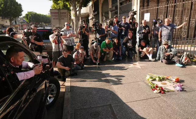 Media gathers at the Walk of Fame star for Rob Reiner Monday, Dec. 15, 2025, in the Hollywood section of Los Angeles. (AP Photo/Damian Dovarganes)