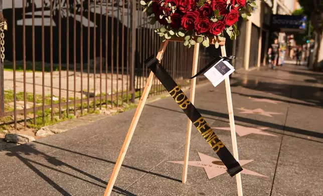 FILE - Flowers are placed at the Walk of Fame star for Rob Reiner Monday, Dec. 15, 2025, in the Hollywood section of Los Angeles. (AP Photo/Damian Dovarganes, File)