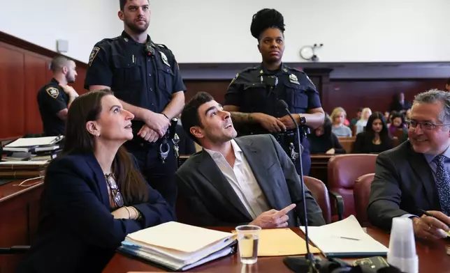 Luigi Mangione appears in court alongside his attorneys Karen Friedman Agnifilo, left, and Marc Agnifilo for an evidence hearing, Thursday, Dec. 4, 2025, in New York. (Angela Weiss/Pool Photo via AP)