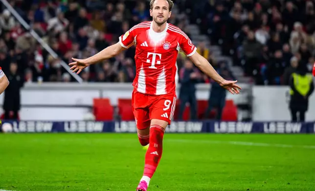 Munich's Harry Kane celebrates after scoring his side's fourth goal during the German Bundesliga soccer match between VfB Stuttgart and FC Bayern Munich in Stuttgart, Germany, Saturday, Dec. 6, 2025. (Tom Weller/dpa via AP)