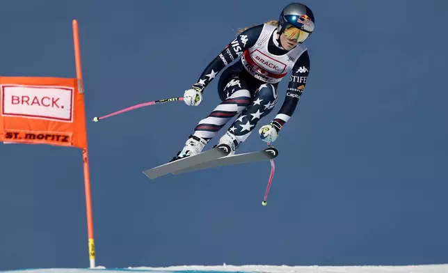 United States' Lindsey Vonn speeds down the course during an alpine ski, women's World Cup downhill in St. Moritz, Switzerland, Friday Dec. 12, 2025. (AP Photo/Gabriele Facciotti)