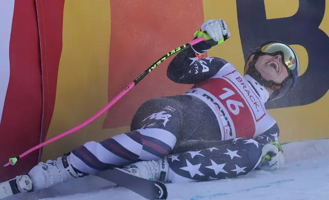 United States' Lindsey Vonn celebrates at the finish area of an alpine ski, women's World Cup downhill in St. Moritz, Switzerland, Friday, Dec.12, 2025. (AP Photo/Luciano Bisi)