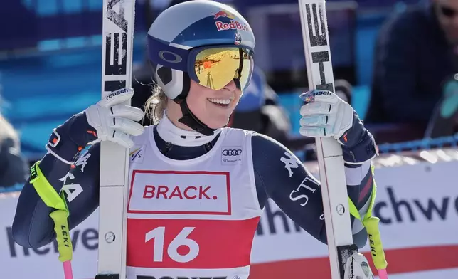 United States' Lindsey Vonn celebrates at the finish area of an alpine ski, women's World Cup downhill in St. Moritz, Switzerland, Friday Dec.12, 2025. (AP Photo/Luciano Bisi)