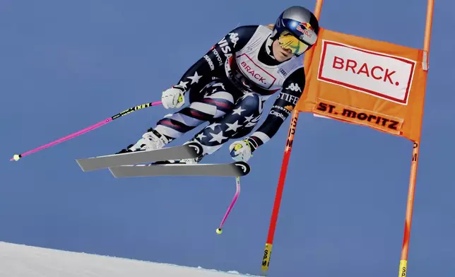 United States' Lindsey Vonn competes in an alpine ski, women's World Cup downhill in St. Moritz, Switzerland, Friday, Dec.12, 2025. (Jean-Christophe Bott/Keystone via AP)