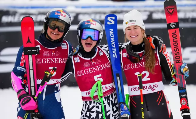 Alice Robinson, of New Zealand, middle, celebrates her first place finish with Zrinka Ljutic , of Croatia, left, who took second and Valerie Grenier, of Canada, who finished third in the women's World Cup giant slalom in Mont Tremblant, Quebec, Saturday, Dec. 6, 2025. (Sean Kilpatrick/The Canadian Press via AP)