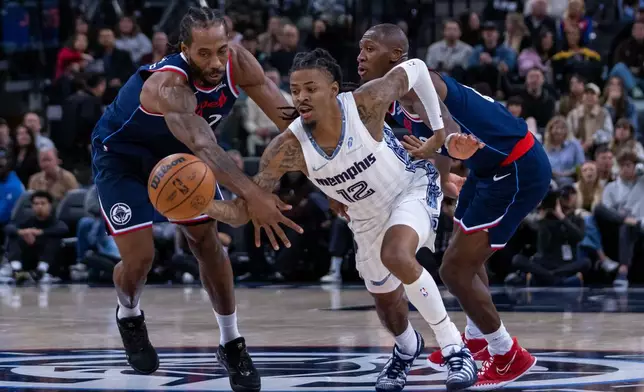 Memphis Grizzlies guard Ja Morant (12) chases the ball against Los Angeles Clippers players during the first half of an NBA basketball game Monday, Dec. 15, 2025, in Inglewood, Calif. (AP Photo/Ethan Swope)
