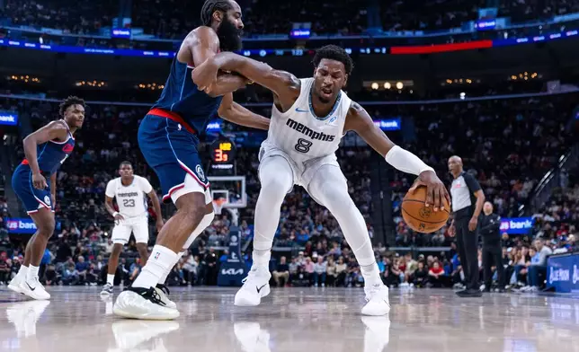 Memphis Grizzlies forward Jaren Jackson Jr. (8) is defended by Los Angeles Clippers guard James Harden, center left, during the first half of an NBA basketball game Monday, Dec. 15, 2025, in Inglewood, Calif. (AP Photo/Ethan Swope)