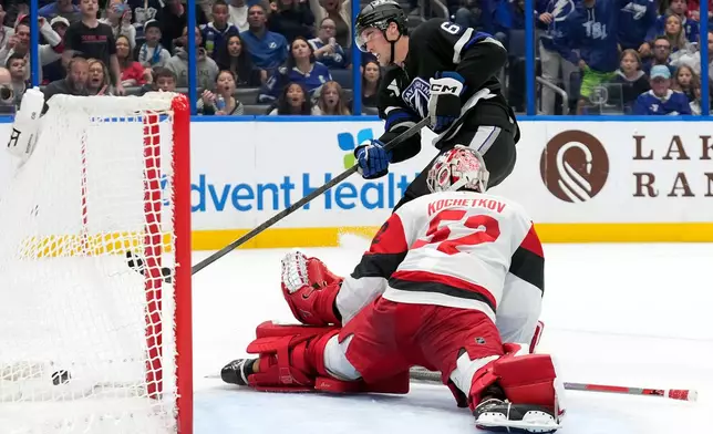 Tampa Bay Lightning center Jack Finley (62) scores past Carolina Hurricanes goaltender Pyotr Kochetkov (52) during the second period of an NHL hockey game Saturday, Dec. 20, 2025, in Tampa, Fla. (AP Photo/Chris O'Meara)