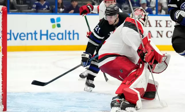 Tampa Bay Lightning center Brayden Point (21) watches his goal get past Carolina Hurricanes goaltender Pyotr Kochetkov (52) during the second period of an NHL hockey game Saturday, Dec. 20, 2025, in Tampa, Fla. (AP Photo/Chris O'Meara)