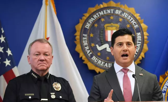First Assistant United States Attorney Bill Essayli, right, speaks in front of LAPD Chief Jim McDonnell during a press conference announcing developments on a terrorism investigation Monday, Dec. 15, 2025, in Los Angeles. (AP Photo/Damian Dovarganes)