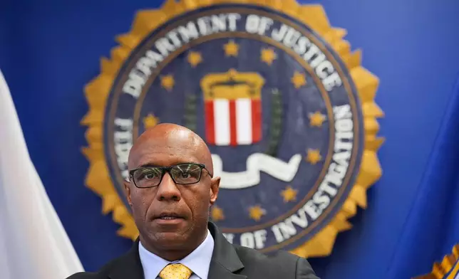 FBI Assistant Director in Charge Akil Davis announces developments on a terrorism investigation during a press conference Monday, Dec. 15, 2025, in Los Angeles. (AP Photo/Damian Dovarganes)