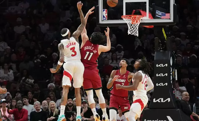 Toronto Raptors forward Brandon Ingram (3) shoots over Miami Heat forward Jaime Jaquez Jr. (11) during the first half of an NBA basketball game, Tuesday, Dec. 23, 2025, in Miami. (AP Photo/Lynne Sladky)