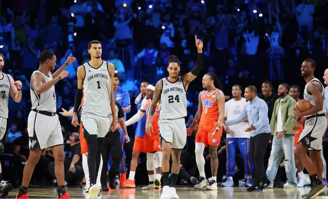 San Antonio Spurs guard Devin Vassell (24) and teammates walk towards their bench at the end of an NBA Cup semifinals basketball game against the Oklahoma City Thunder, Saturday, Dec. 13, 2025, in Las Vegas. (AP Photo/Ronda Churchill)