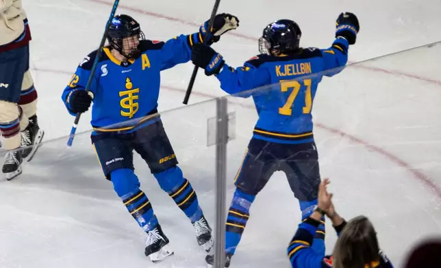 Toronto Sceptres' Anna Kjellbin (71) celebrates her goal against the Montreal Victoire with Allie Munroe (12) during the first period of a PWHL Takeover Tour game in Halifax, on Wednesday, Dec. 17, 2025. (Riley Smith/The Canadian Press via AP)