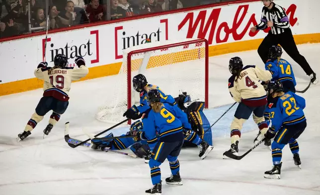 Montreal Victoire's Kaitlin Willoughby (19) celebrates her goal on Toronto Sceptres goaltender Raygan Kirk (1) during the first period of a PWHL Takeover Tour game in Halifax, on Wednesday, Dec. 17, 2025. (Riley Smith/The Canadian Press via AP)