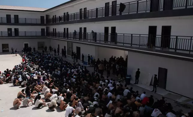 FILE - People from China, Vietnam and Ethiopia, believed to have been trafficked and forced to work in scam centers, sit with their faces masked while in detention after being released from the centers in Myawaddy district in eastern Myanmar, Wednesday, Feb. 26, 2025. (AP Photo/Thanaphon Wuttison, File)