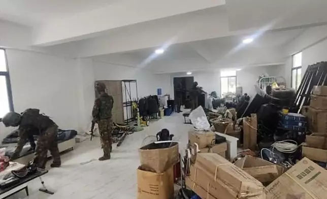 FILE - In this image provided by the Myanmar military on Oct. 19, 2025, soldiers raid the KK Park online scam center in Myawaddy township, Karen State, Myanmar. (The Myanmar Military True News Information Team via AP, File)