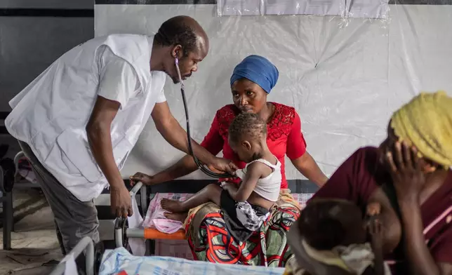 FILE - Dr. Toussaint Selemani checks a child with measles at the Kachehembe Health Center in Rubaya, eastern Democratic Republic of Congo, Dec. 1, 2025. (AP Photo/Moses Sawasawa, File)