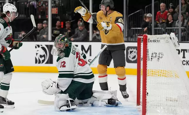Vegas Golden Knights right wing Mark Stone (61) celebrates after a goal by Vegas Golden Knights defenseman Brayden McNabb against Minnesota Wild goaltender Filip Gustavsson (32) during the second period of an NHL hockey game Monday, Dec. 29, 2025, in Las Vegas. (AP Photo/John Locher)