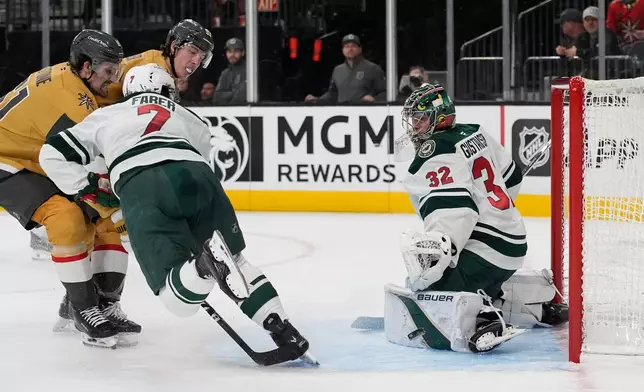 Minnesota Wild goaltender Filip Gustavsson (32) watches the puck travel by during the second period of an NHL hockey game against the Vegas Golden Knights, Monday, Dec. 29, 2025, in Las Vegas. (AP Photo/John Locher)