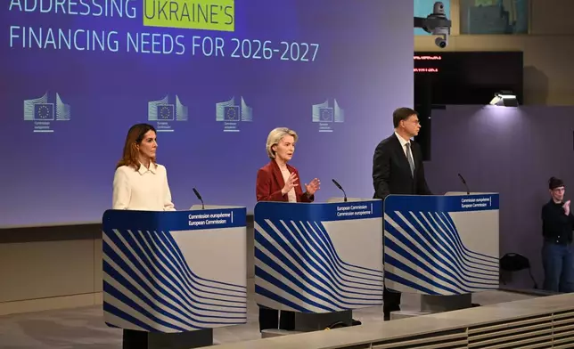 European Commission President Ursula von der Leyen, center, and European Commissioner for Economy and Productivity, Implementation and Simplification Valdis Dombrovskis, right, address a media conference regarding Ukraine's financing needs for 2026-2027 at EU headquarters in Brussels, Wednesday, Dec. 3, 2025. (AP Photo/Harry Nakos)