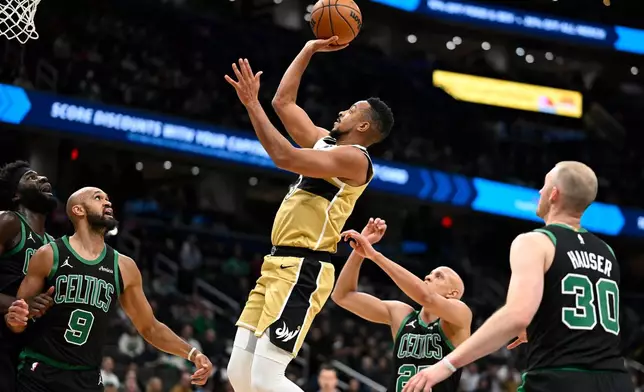 Washington Wizards guard CJ McCollum goes up to score during the first half of an NBA basketball game against the Boston Celtics, Thursday, Dec. 4, 2025, in Washington. (AP Photo/John McDonnell)