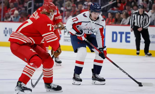 Washington Capitals center Dylan Strome (17) drives towards the goal against Detroit Red Wings defenseman Simon Edvinsson (77) during the second period of an NHL hockey game Sunday, Dec. 21, 2025, in Detroit. (AP Photo/Duane Burleson)