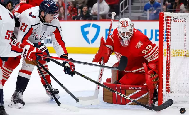 Washington Capitals center Aliaksei Protas (21) can't score against Detroit Red Wings goaltender Cam Talbot (39) during the second period of an NHL hockey game Sunday, Dec. 21, 2025, in Detroit. (AP Photo/Duane Burleson)