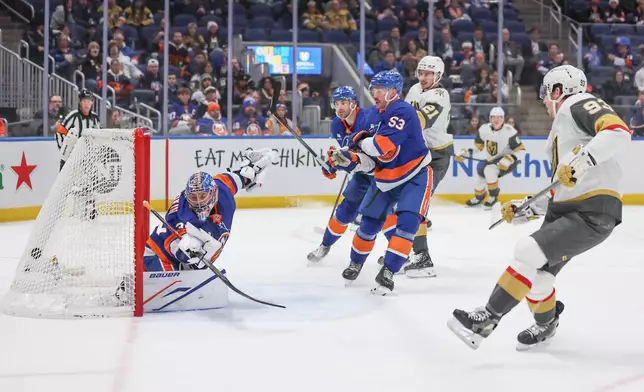 New York Islanders goaltender Ilya Sorokin (30) watches the puck go through the net after a goal by Vegas Golden Knights' Mitch Marner (93) during the first period of an NHL hockey game, Tuesday, Dec. 9, 2025, in Elmont, N.Y. (AP Photo/Heather Khalifa)