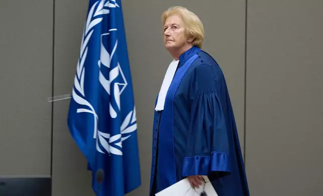 Presiding judge Joanna Korner enters the court room to read the verdict for Ali Muhammad Ali Abd al-Rahman, a leader of the Sudanese Janjaweed militia, at the International Criminal Court, ICC, in The Hague, Netherlands, Tuesday, Dec. 9, 2025. (AP Photo/Peter Dejong, Pool)