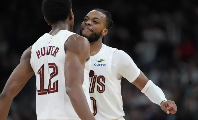 Cleveland Cavaliers guard Darius Garland, right, celebrates a play with teammate forward De'Andre Hunter (12) during the second half of an NBA basketball game against the San Antonio Spurs in San Antonio, Monday, Dec. 29, 2025. (AP Photo/Eric Gay)