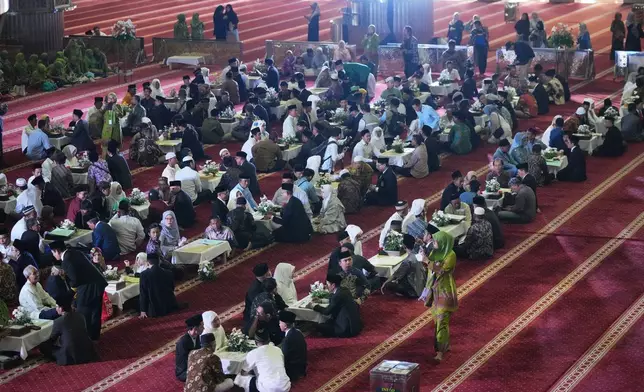 Brides and grooms prepare for a mass wedding ceremony at Istiqlal Mosque in Jakarta, Indonesia, Wednesday, Dec. 3, 2025. (AP Photo/Tatan Syuflana)