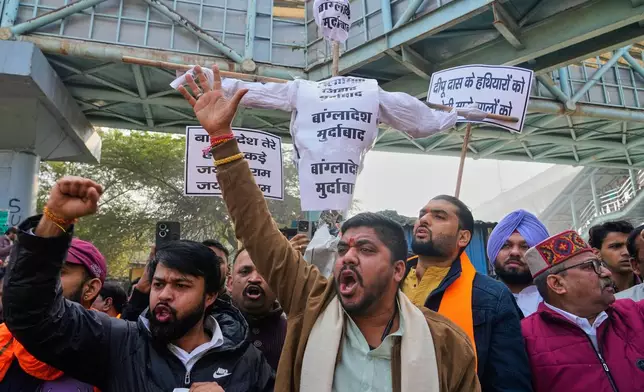 Activists of Vishwa Hindu Parishad, a prominent right-wing Hindu nationalist organization, shout slogans during a protest near Bangladesh High Commission accusing Bangladeshi groups of wrongly targeting Indians, in New Delhi, India, Tuesday, Dec.23, 2025. (AP Photo/Manish Swarup)