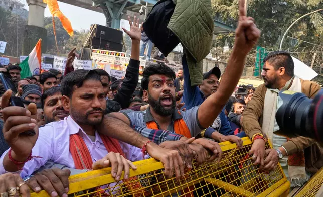 Activists of Vishwa Hindu Parishad, a prominent right-wing Hindu nationalist organization, shout slogans during a protest near Bangladesh High Commission accusing Bangladeshi groups of wrongly targeting Indians, in New Delhi, India, Tuesday, Dec.23, 2025. (AP Photo/Manish Swarup)