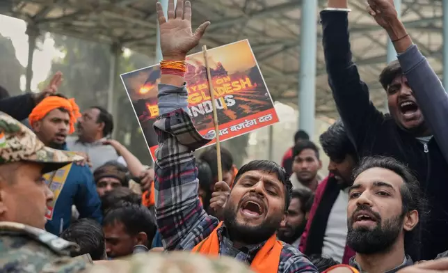 Activists of Vishwa Hindu Parishad, a prominent right-wing Hindu nationalist organization, shout slogans during a protest near Bangladesh High Commission accusing Bangladeshi groups of wrongly targeting Indians, in New Delhi, India, Tuesday, Dec.23, 2025. (AP Photo/Manish Swarup)