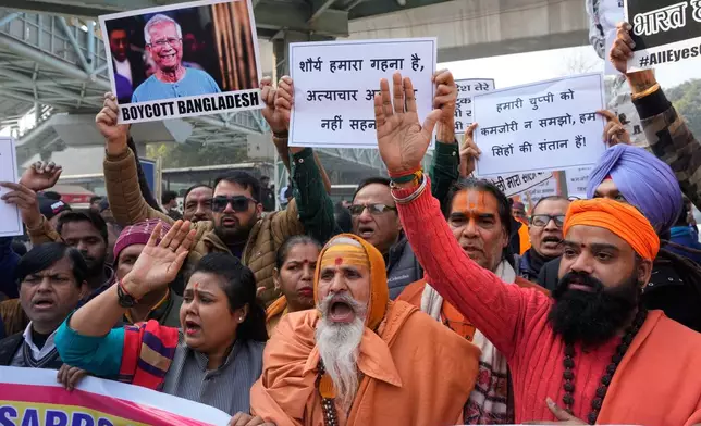 Activists of Vishwa Hindu Parishad, a prominent right-wing Hindu nationalist organization, shout slogans during a protest near Bangladesh High Commission accusing Bangladeshi groups of wrongly targeting Indians, in New Delhi, India, Tuesday, Dec.23, 2025. (AP Photo/Manish Swarup)