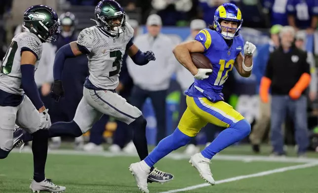 Los Angeles Rams wide receiver Puka Nacua (12) runs with the ball during the second half of an NFL football game against the Seattle Seahawks, Thursday, Dec. 18, 2025, in Seattle. (AP Photo/John Froschauer)