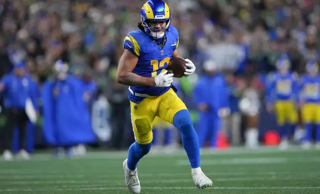 Los Angeles Rams wide receiver Puka Nacua runs for a touchdown during overtime in an NFL football game against the Seattle Seahawks, Thursday, Dec. 18, 2025, in Seattle. (AP Photo/Lindsey Wasson)
