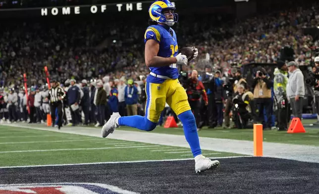 Los Angeles Rams wide receiver Puka Nacua scores a touchdown during overtime in an NFL football game against the Seattle Seahawks, Thursday, Dec. 18, 2025, in Seattle. (AP Photo/Lindsey Wasson)