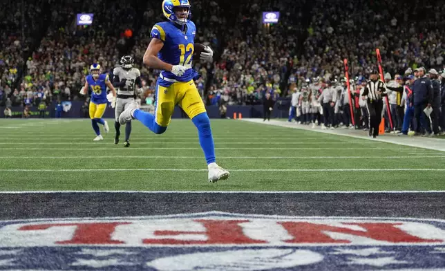 Los Angeles Rams wide receiver Puka Nacua scores a touchdown during overtime in an NFL football game against the Seattle Seahawks, Thursday, Dec. 18, 2025, in Seattle. (AP Photo/Lindsey Wasson)