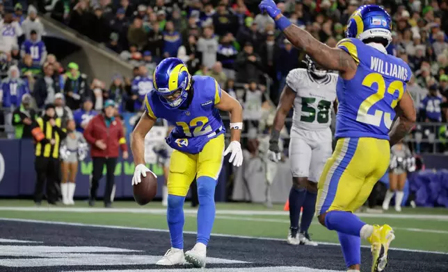 Los Angeles Rams wide receiver Puka Nacua (12) scores a touchdown during the second half of an NFL football game against the Seattle Seahawks, Thursday, Dec. 18, 2025, in Seattle. (AP Photo/John Froschauer)