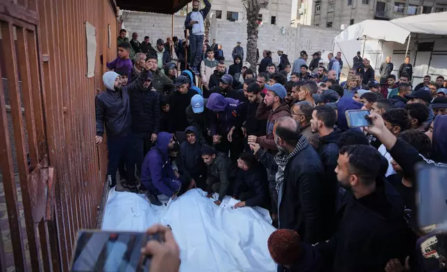Palestinians mourn during the funeral of people who were killed in an Israeli military strike, at Nasser Hospital in Khan Younis, Gaza Strip, Thursday, Dec. 4, 2025. (AP Photo/Abdel Kareem Hana)