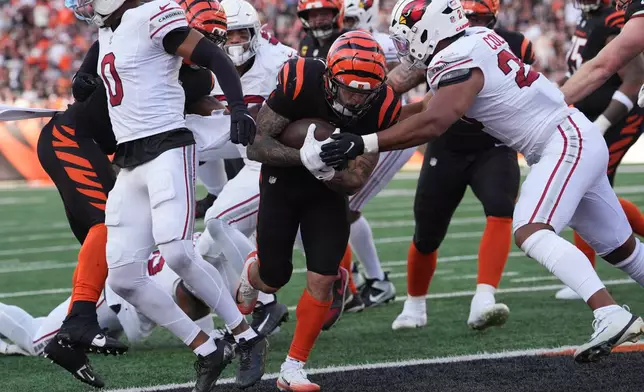 Cincinnati Bengals halfback Chase Brown, center, runs into the endzone for a touchdown during the second half of an NFL football game against the Arizona Cardinals, Sunday, Dec. 28, 2025, in Cincinnati. (AP Photo/Joshua A. Bickel)