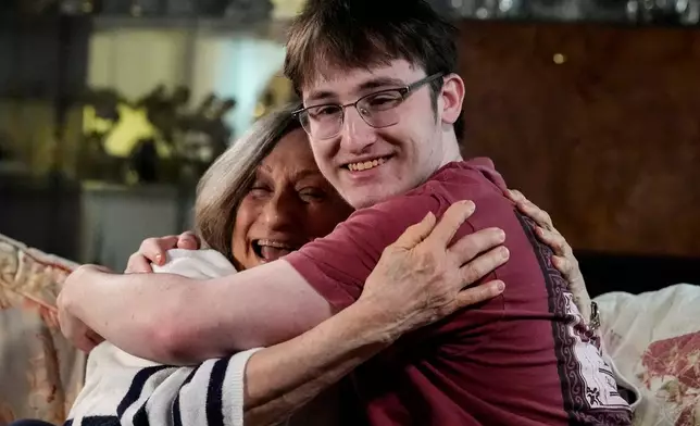 Donna West and her grandson Paul Quirk embrace during an interview, Tuesday, Dec. 2, 2025, in Marietta, Ga. (AP Photo/Mike Stewart)