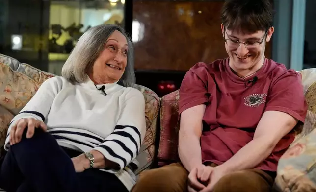 Donna West sits with her grandson Paul Quirk as they speak to a reporter, Tuesday, Dec. 2, 2025, in Marietta, Ga. (AP Photo/Mike Stewart)