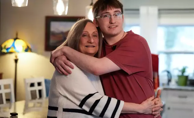 Donna West and her grandson Paul Quirk pose for a photo, Tuesday, Dec. 2, 2025, in Marietta, Ga. (AP Photo/Mike Stewart)