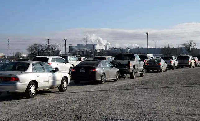 Drivers wait in line at a mobile food bank organized by Crossroads Mission Avenue near the Tyson Foods' beef plant in Lexington, Neb., Thursday, Dec. 4, 2025. (AP Photo/Thomas Peipert)