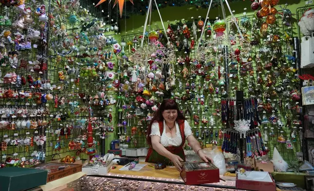 Owner of the Christel Dauwe Collection ornaments shop, Christel Dauwe, wraps boxes of holiday ornaments at her shop in Antwerp, Belgium, Monday, Dec. 8, 2025. (AP Photo/Virginia Mayo)