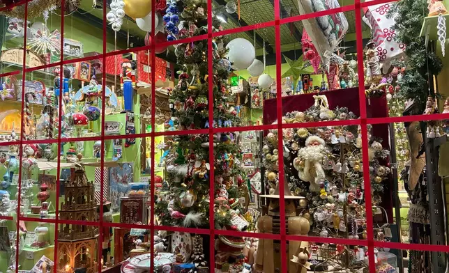 Holiday ornaments are seen through the window of the Christel Dauwe Collection ornaments shop in Antwerp, Belgium, Saturday, Dec. 6, 2025. (AP Photo/Virginia Mayo)
