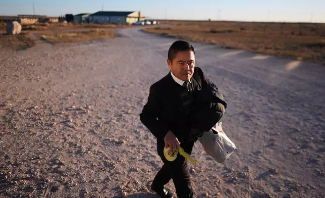 Former Chinese official Li Chuanliang walks between buildings in the Mayflower Church community, in Midland, Texas, Jan. 19, 2025. (AP Photo/Rebecca Blackwell)